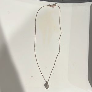 has a gold chain, diamond circle